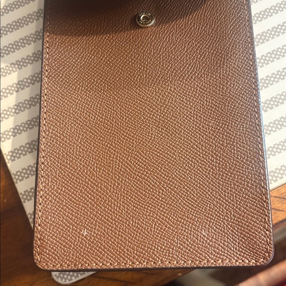 Coach brown cellphone crossbody bag with chain strap. In very good condition